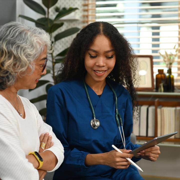 Smiling physician discussing treatment with senior female patient