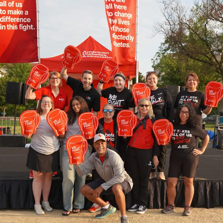 Smiling group of ADA volunteers with foam oversized gloves