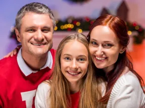 Smiling young teen girl with mother and father