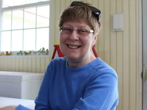 Photo of Kaye sitting in a chair