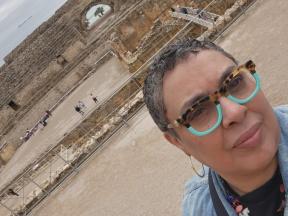 Photo of Maria in front of historic site