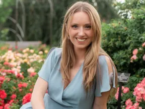 Photo of Kathryn sitting with CGM showing on arm