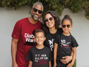 Smiling family of four wearing shirts that say "Diabetes Warrior" and "Beat Diabetes."