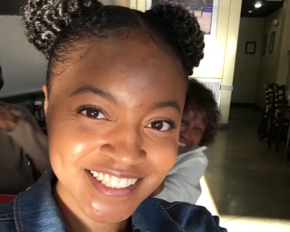 Woman taking a selfie and smiling at the camera