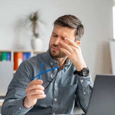 A man rubs at his dry eyes caused by diabetes related dry eye syndrome
