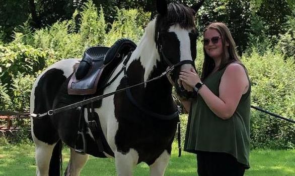 Alysa standing with her horse