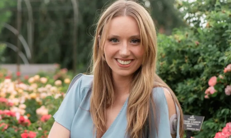 Photo of Kathryn sitting with CGM showing on arm