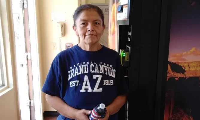 A woman standing next to a vending machine