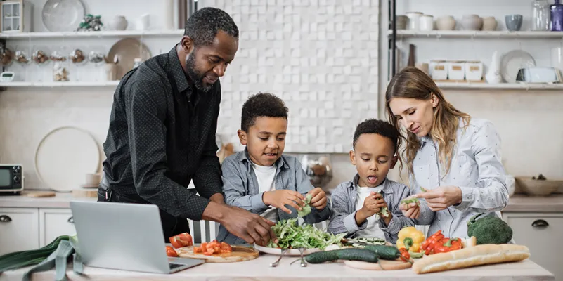 multinational mom and dad enjoying healthy cooking