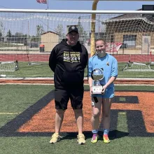 Photo of Brooke holding a trophy