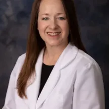 Photo of woman in white coat