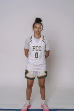 Female athlete in white "FCC 0" basketball uniform.