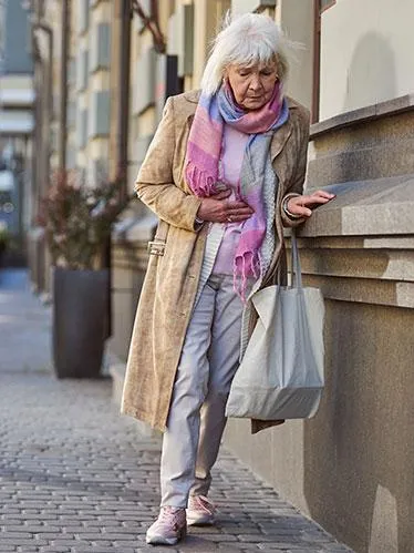 senior-woman-leaning-wall
